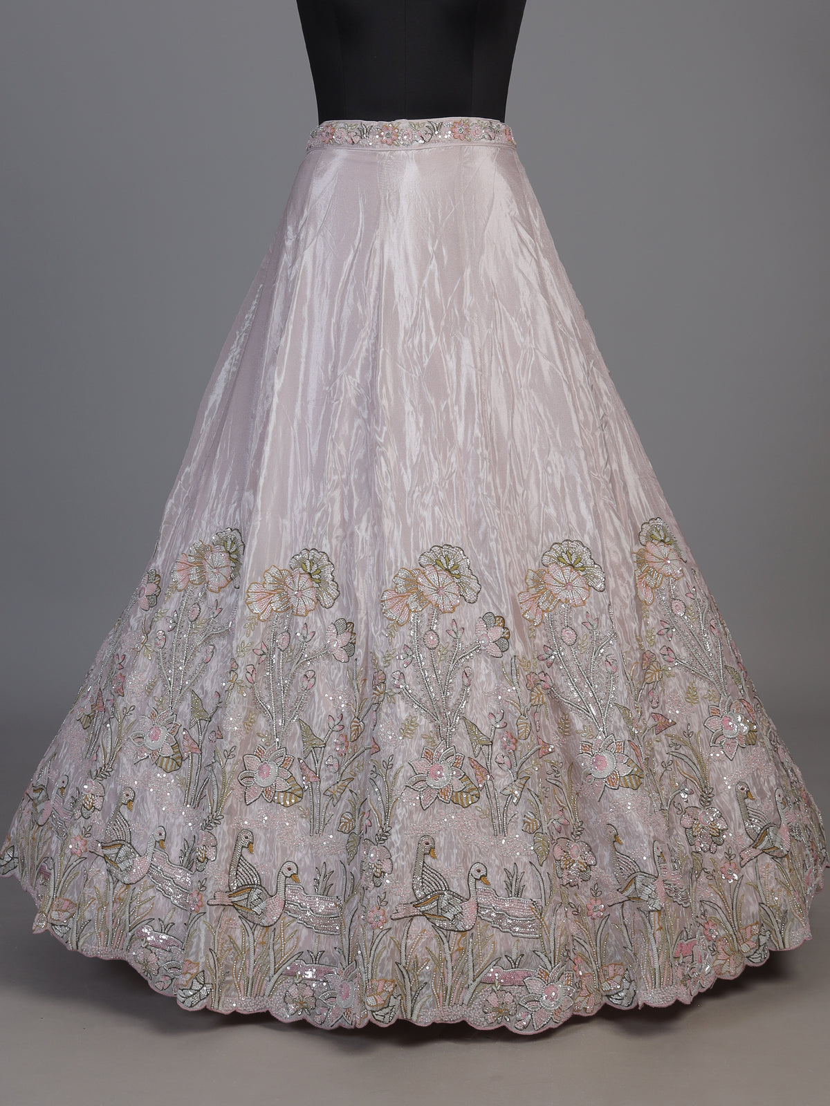 Pink tissue silk lehenga choli adorned with floral bird artistry