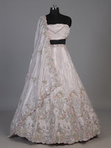 Pink tissue silk lehenga choli adorned with floral bird artistry