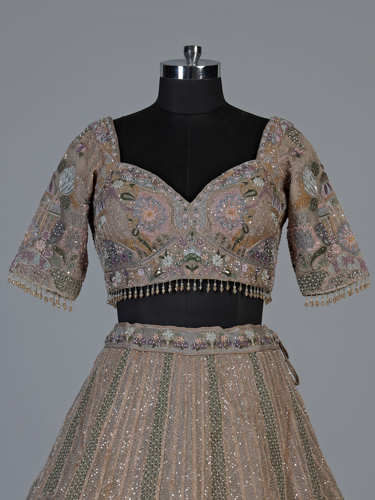 Beige tissue silk lehenga choli with luxurious designer embellishments