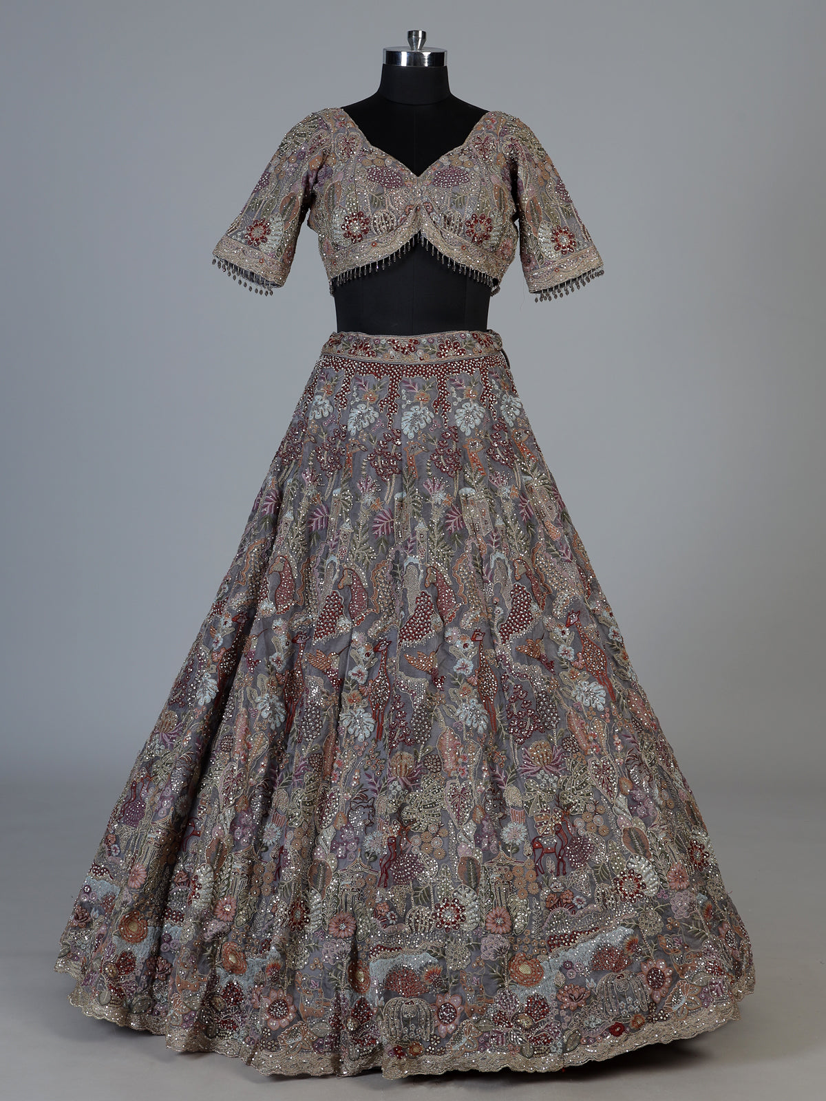 Grey silk lehenga choli with ornate floral and animal motifs