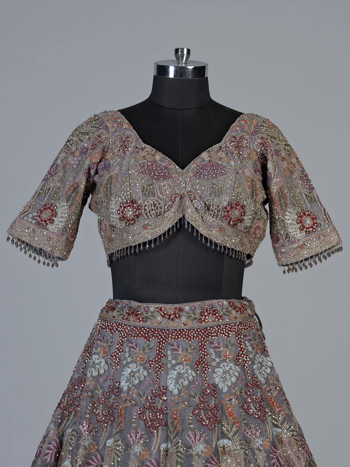Grey silk lehenga choli with ornate floral and animal motifs