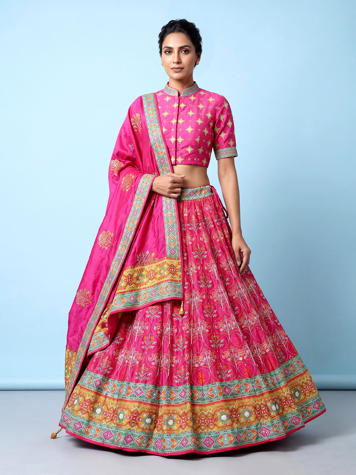 Rani pink silk unstitched lehenga choli with sparkling traditional detailing