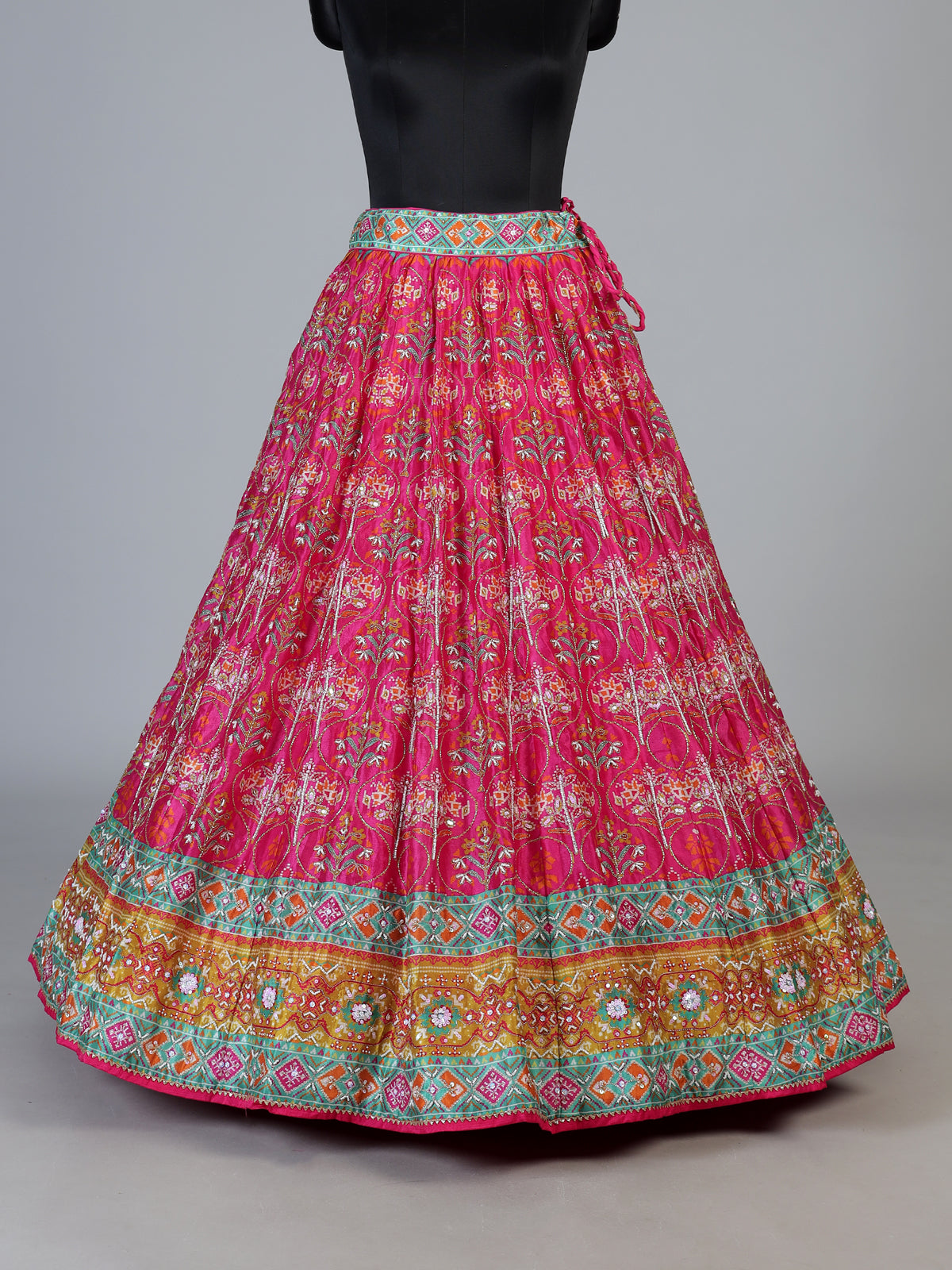 Rani pink silk unstitched lehenga choli with sparkling traditional detailing