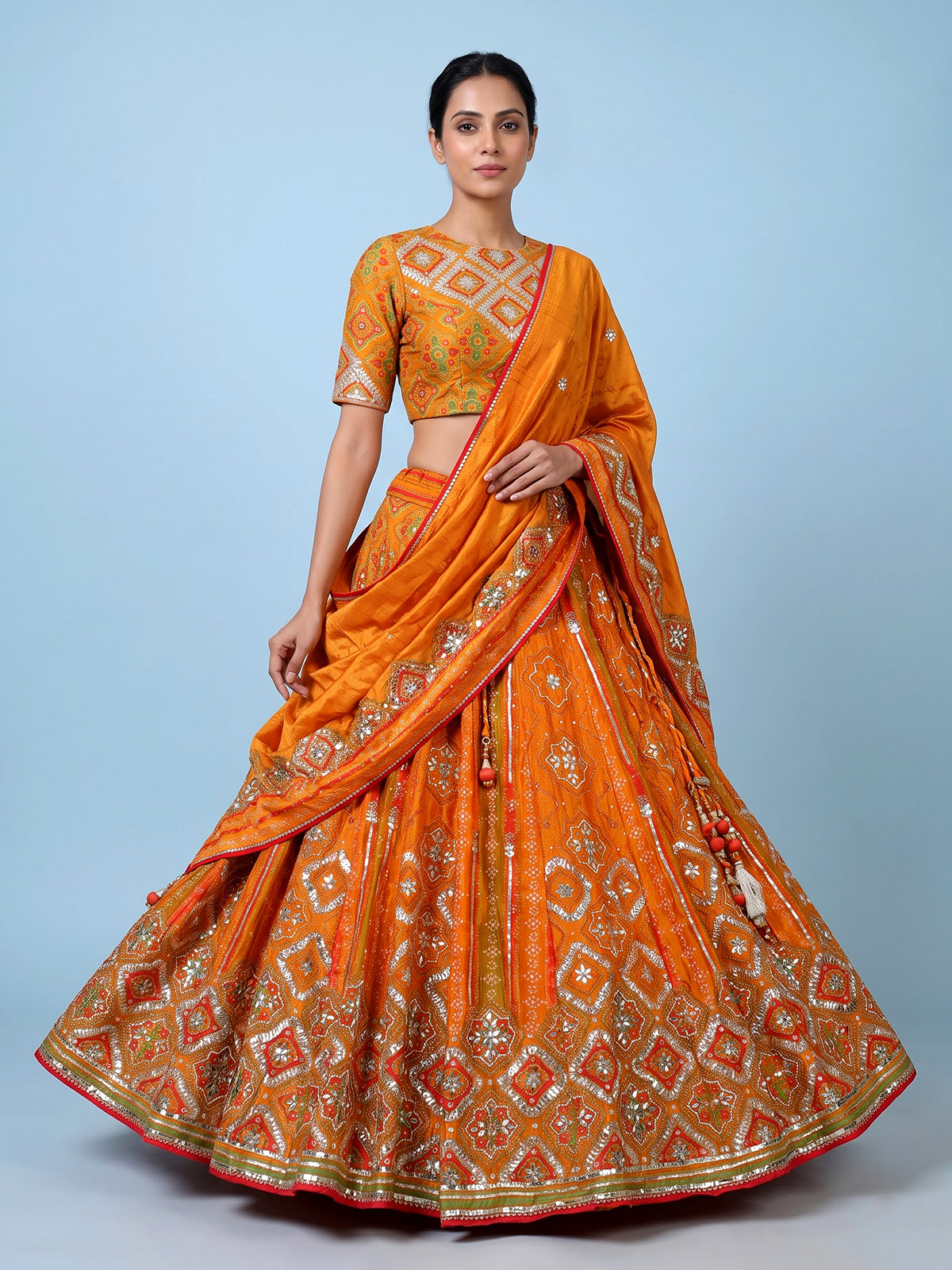 Orange silk unstitched lehenga choli with bandhani elegance