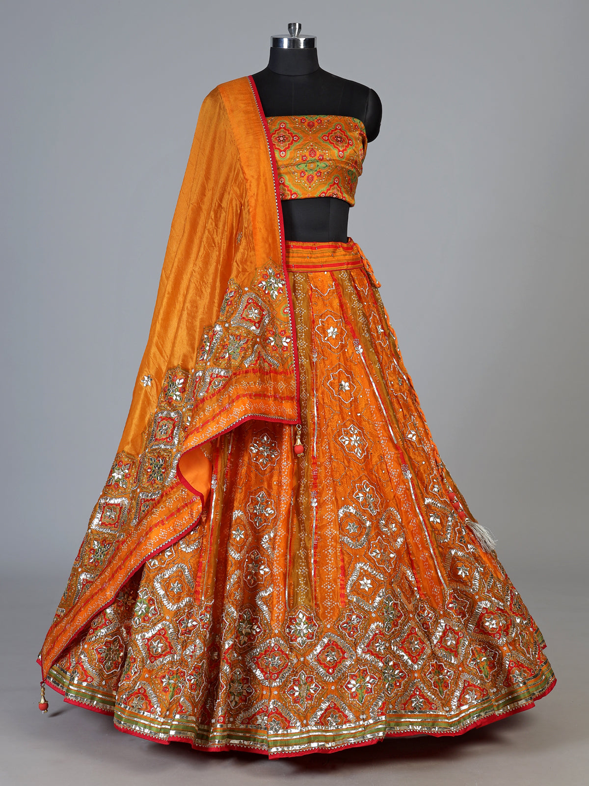 Orange silk unstitched lehenga choli with bandhani elegance