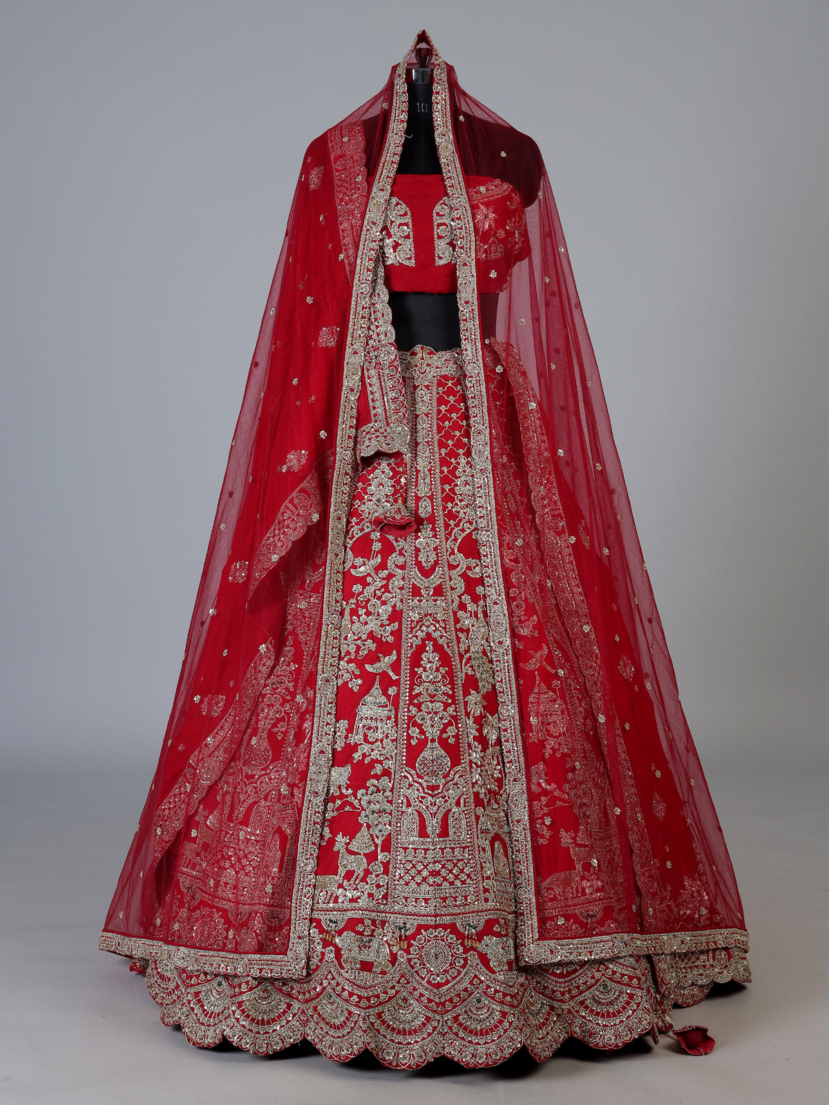 Red raw silk unstitched bridal lehenga choli with ornate craftsmanship
