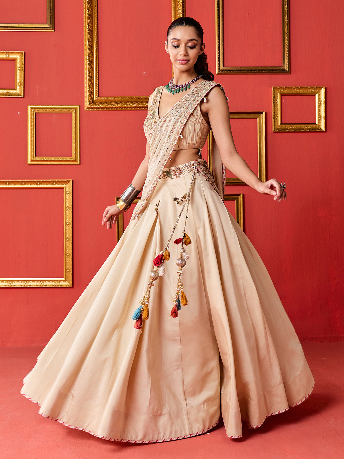 Beige silk designer lehenga choli with tassel accents dupatta