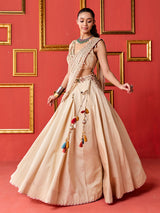Beige silk designer lehenga choli with tassel accents dupatta