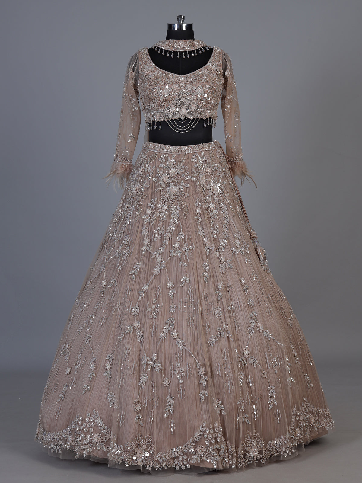 Beige net lehenga choli with pearls diamonds and tassel detailing