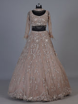 Beige net lehenga choli with pearls diamonds and tassel detailing