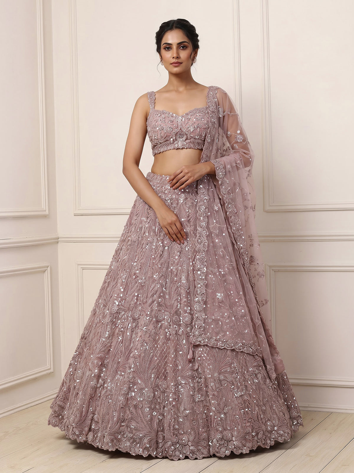 Onion pink net lehenga choli with sparkling heavy embellishments