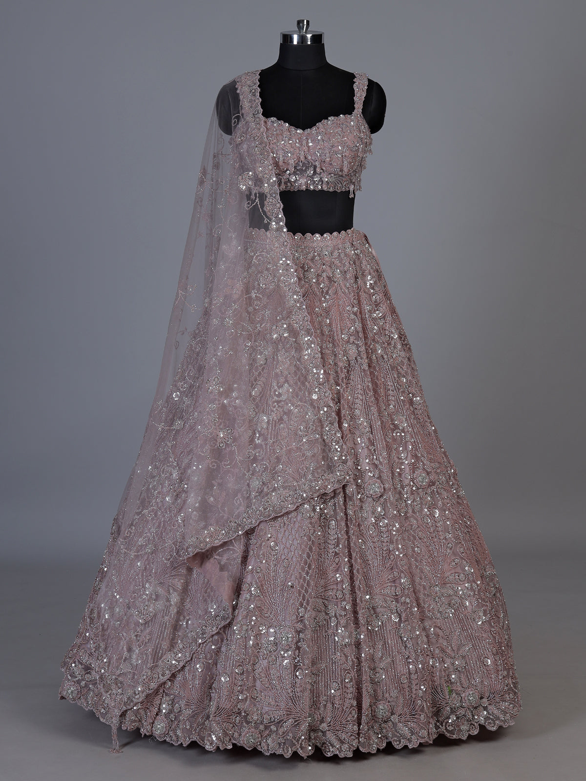 Onion pink net lehenga choli with sparkling heavy embellishments