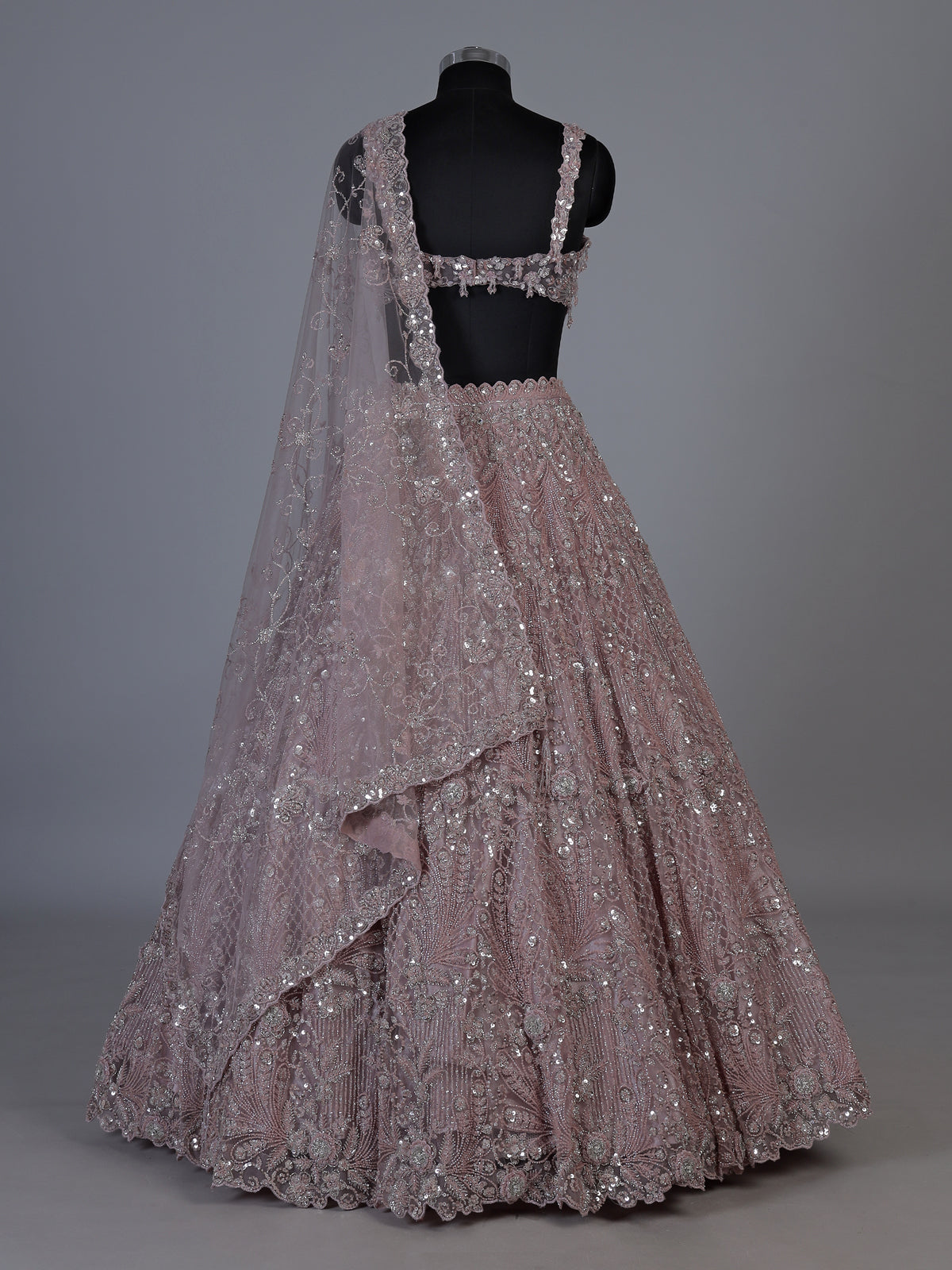 Onion pink net lehenga choli with sparkling heavy embellishments