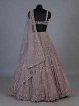 Onion pink net lehenga choli with sparkling heavy embellishments