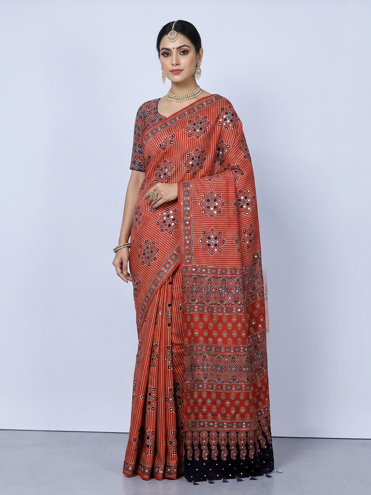 Red crepe silk saree with shimmering mirror printed accents