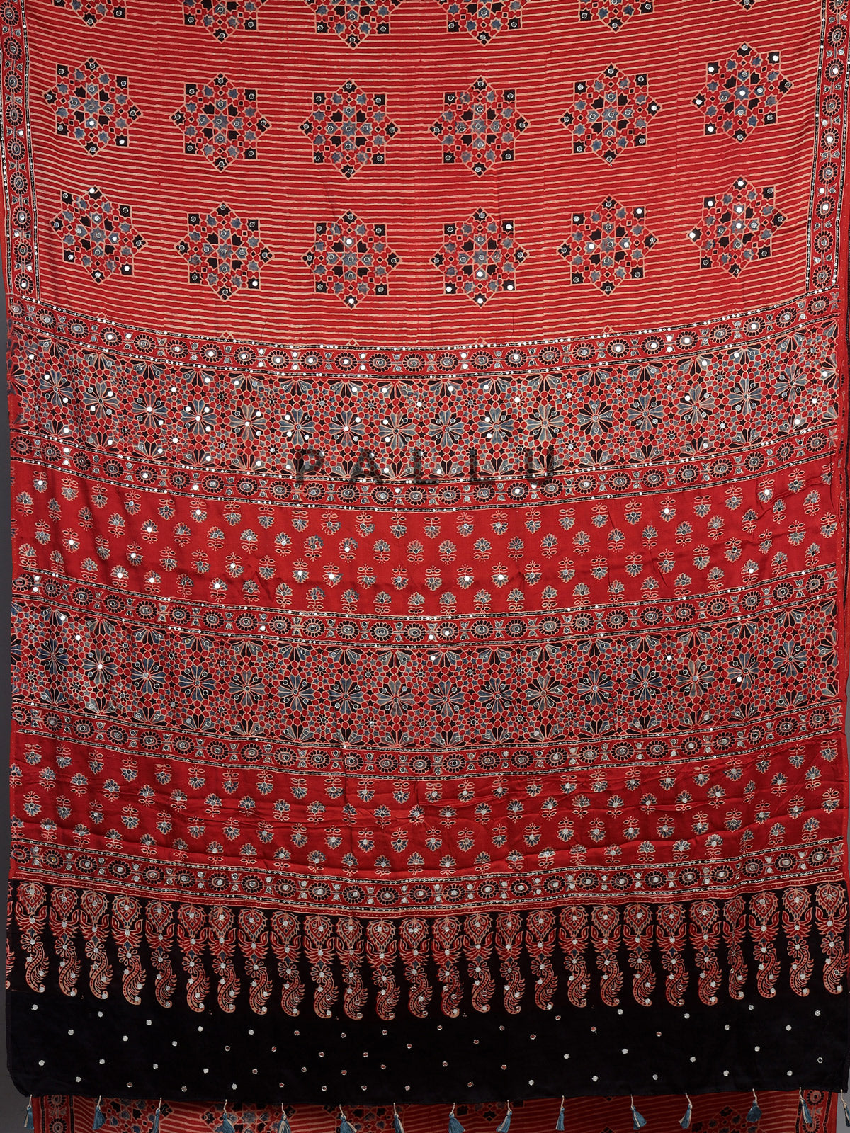 Red crepe silk saree with shimmering mirror printed accents
