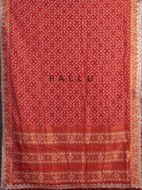 Rust orange soft silk saree with graceful ikat printed detailing