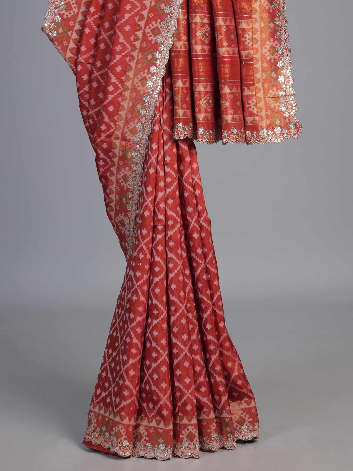 Rust orange soft silk saree with graceful ikat printed detailing
