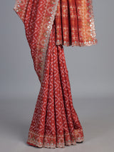 Rust orange soft silk saree with graceful ikat printed detailing