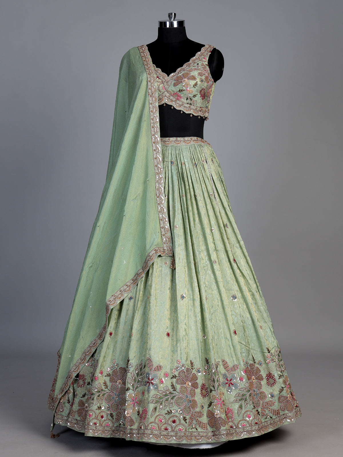 Pista green silk lehenga with zardosi festive detailing