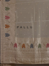 Pastel beige silk saree with delicate traditional embellishments