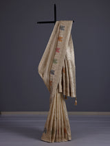 Pastel beige silk saree with delicate traditional embellishments