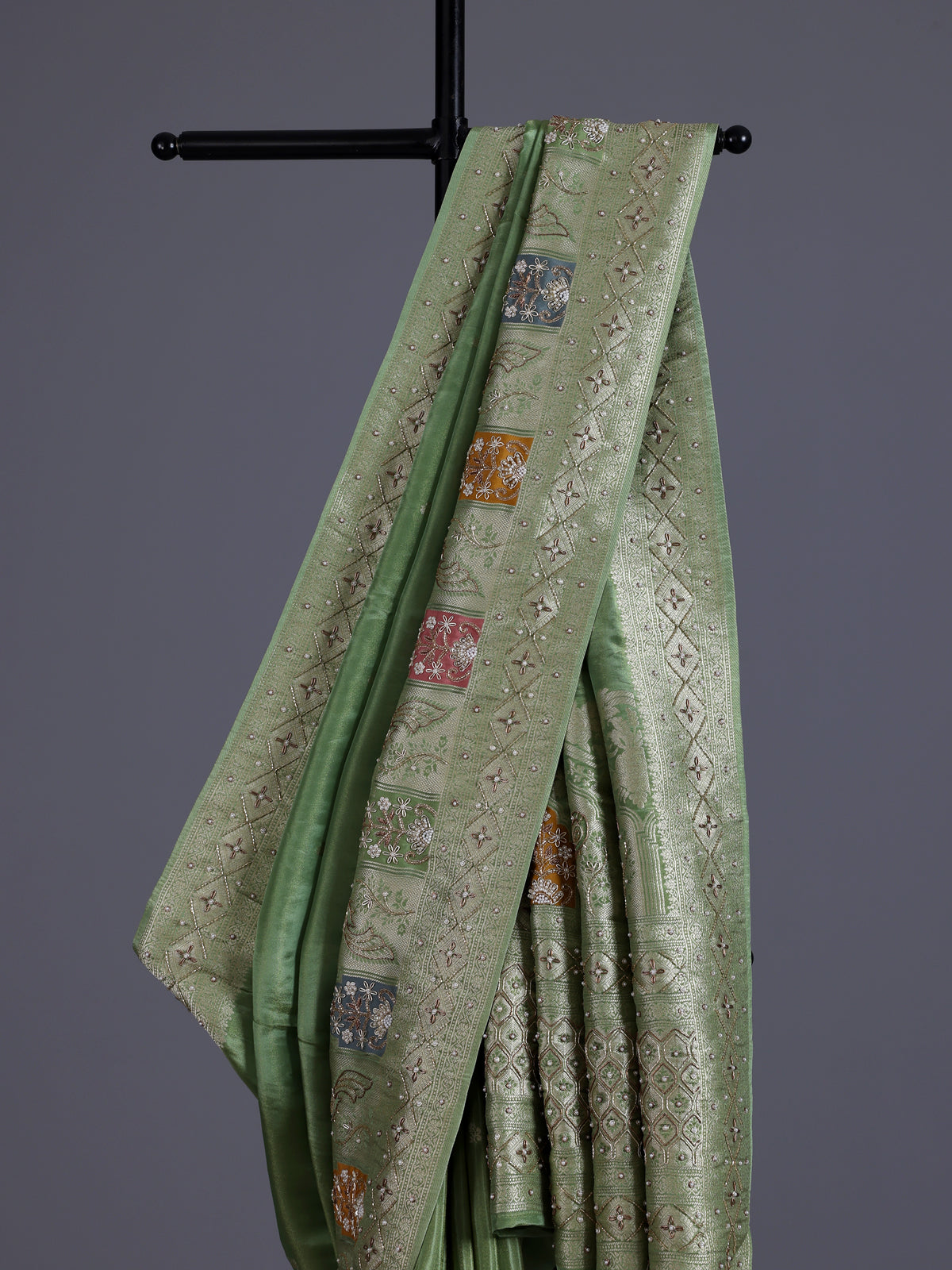 Pista green silk saree with elegant peacock motif embellishments