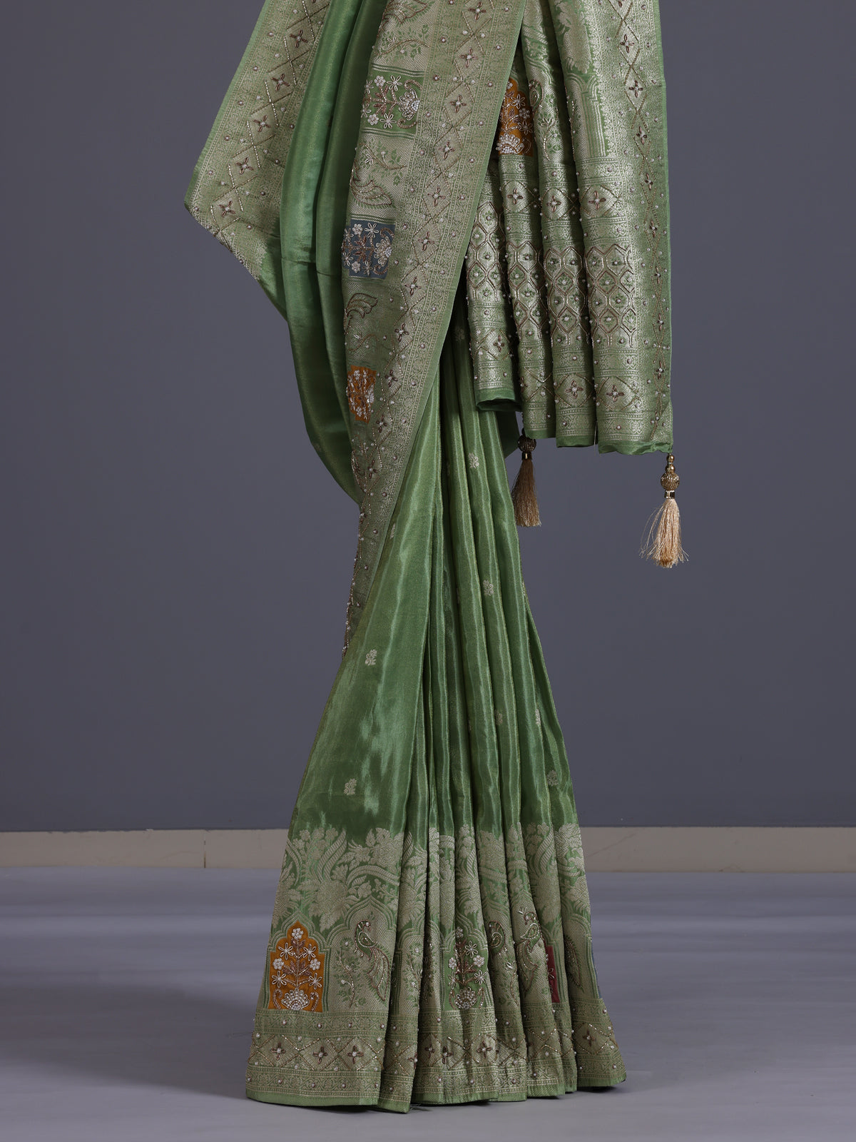 Pista green silk saree with elegant peacock motif embellishments