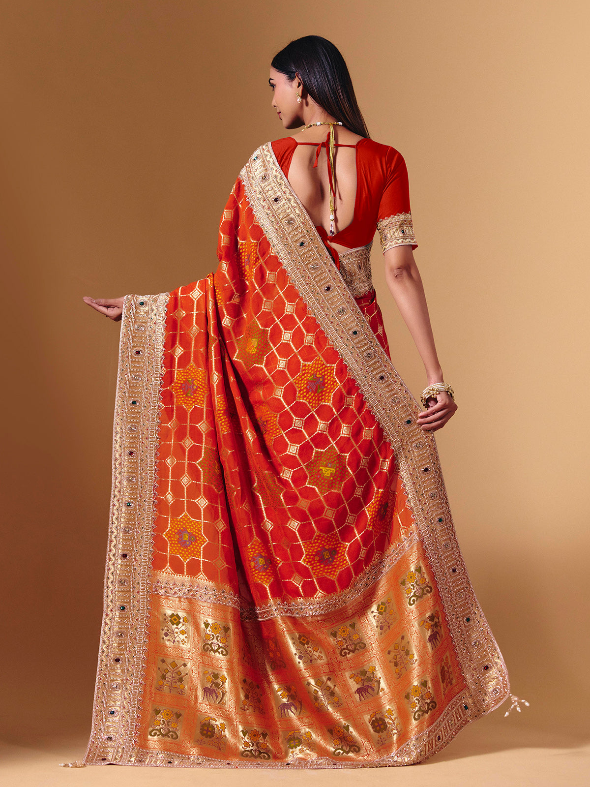Orange georgette saree with sparkling animal motif detailing