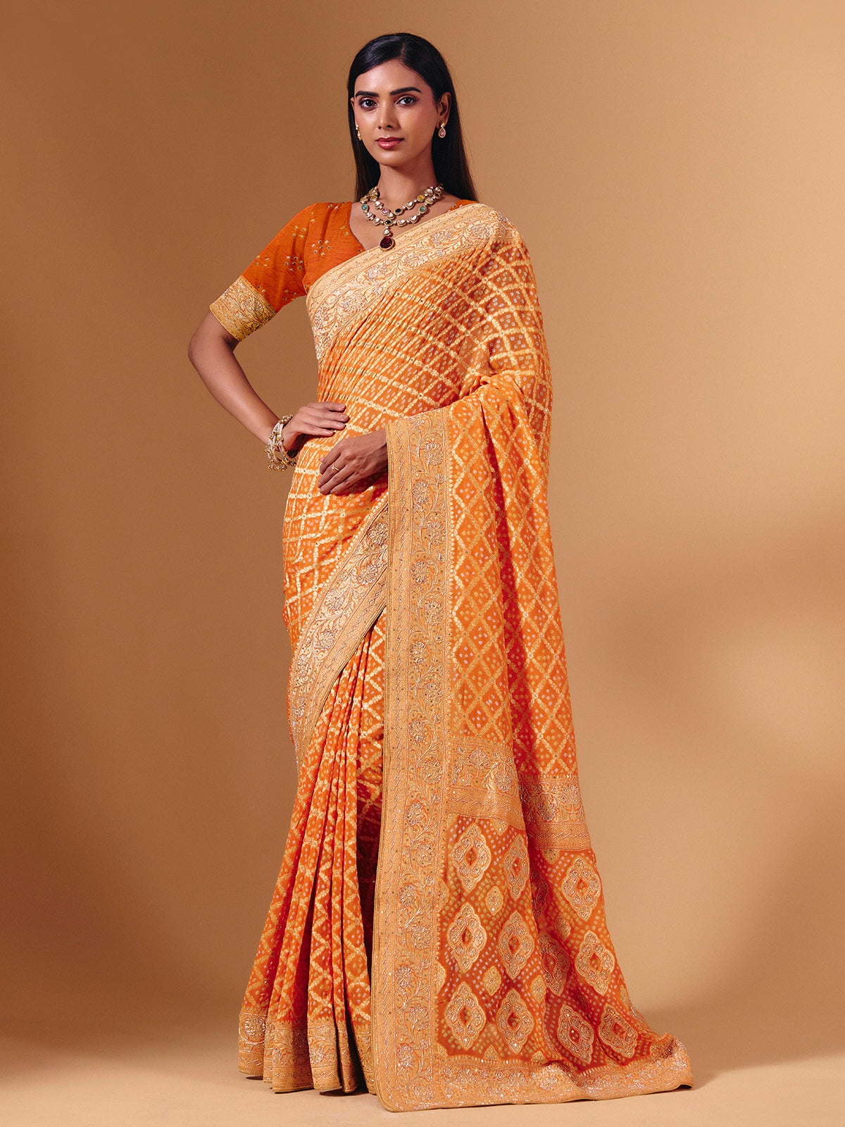 Orange georgette saree with bandhani print and zardosi embellishments