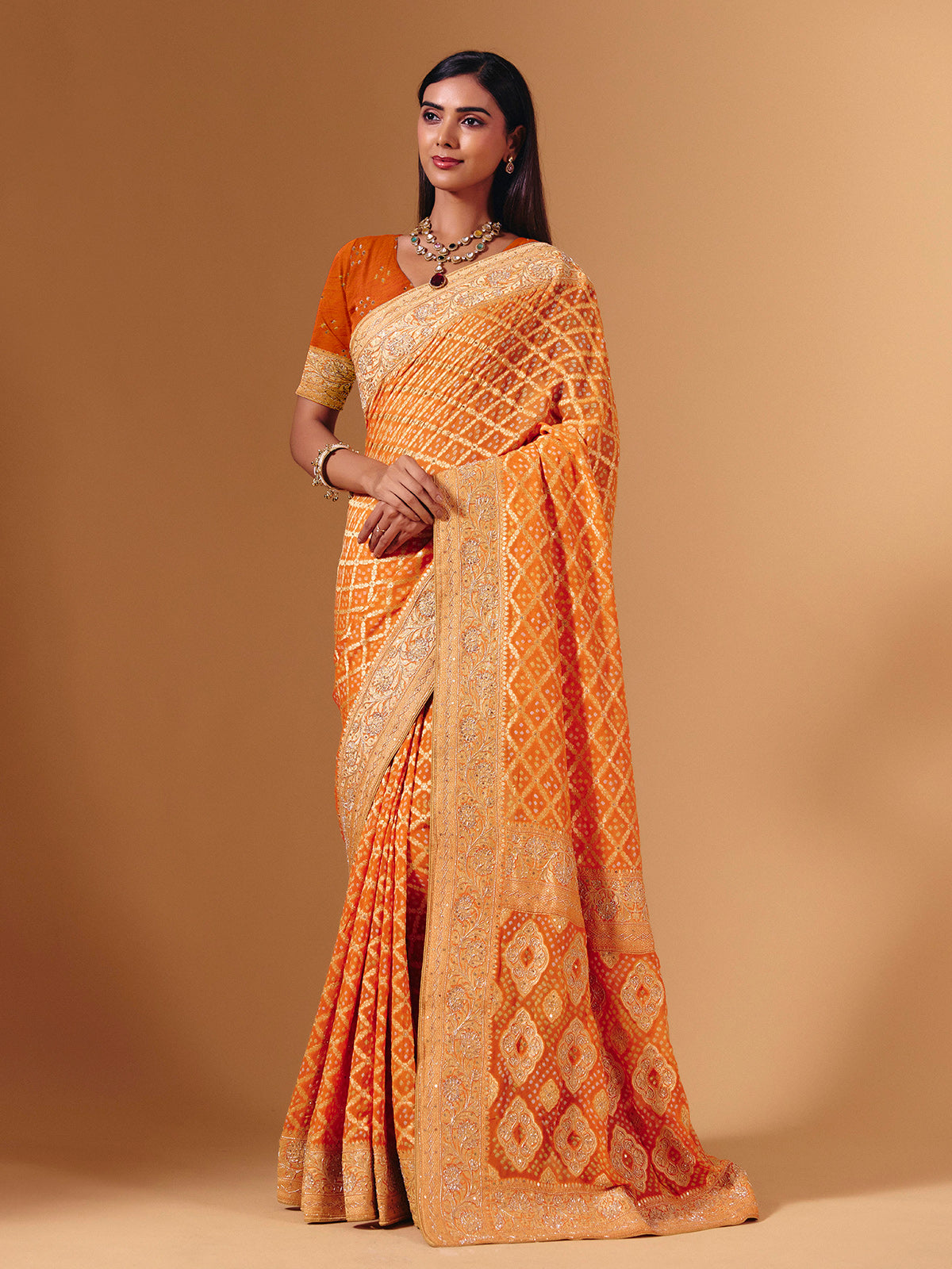 Orange georgette saree with bandhani print and zardosi embellishments