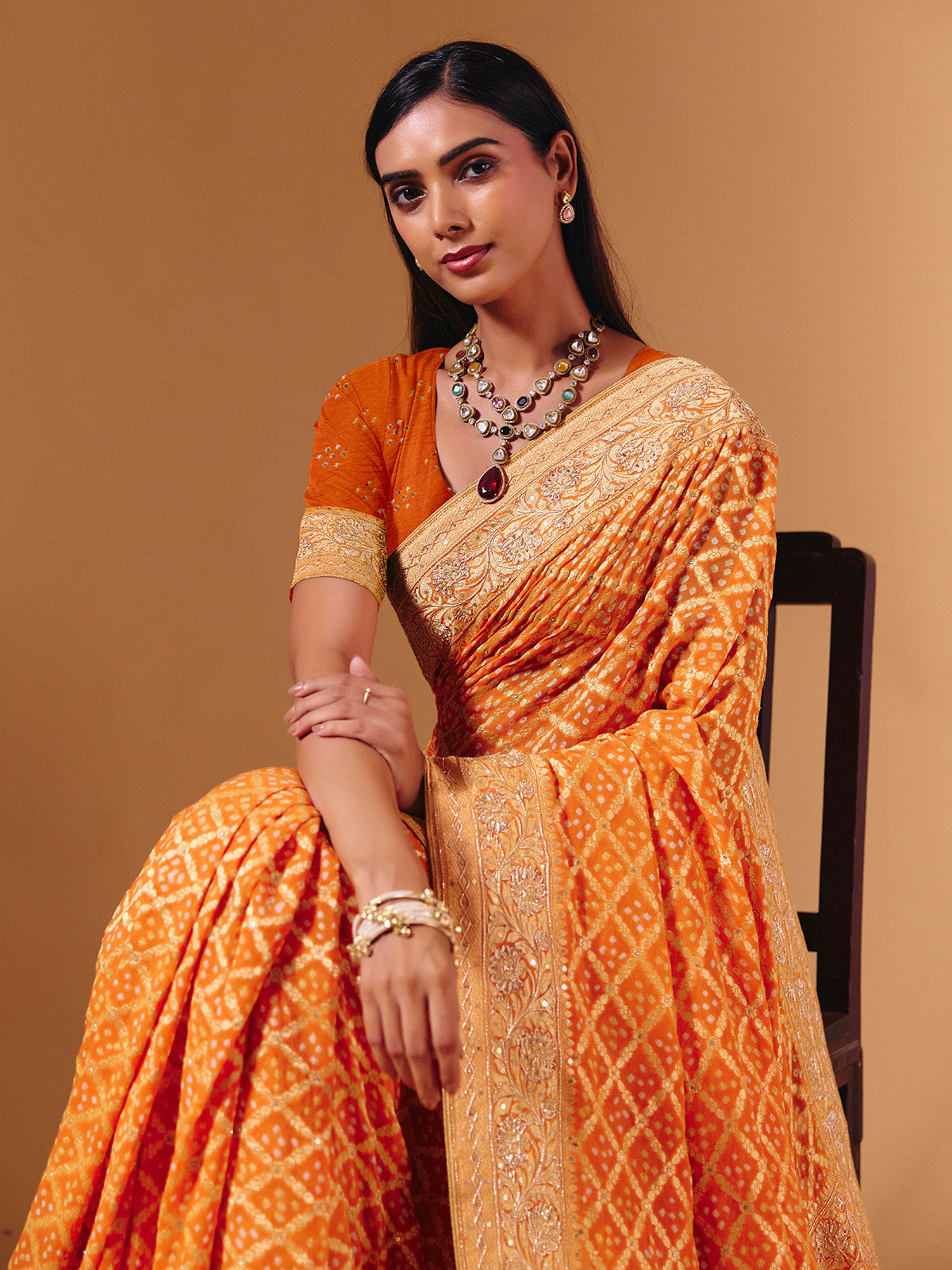 Orange georgette saree with bandhani print and zardosi embellishments