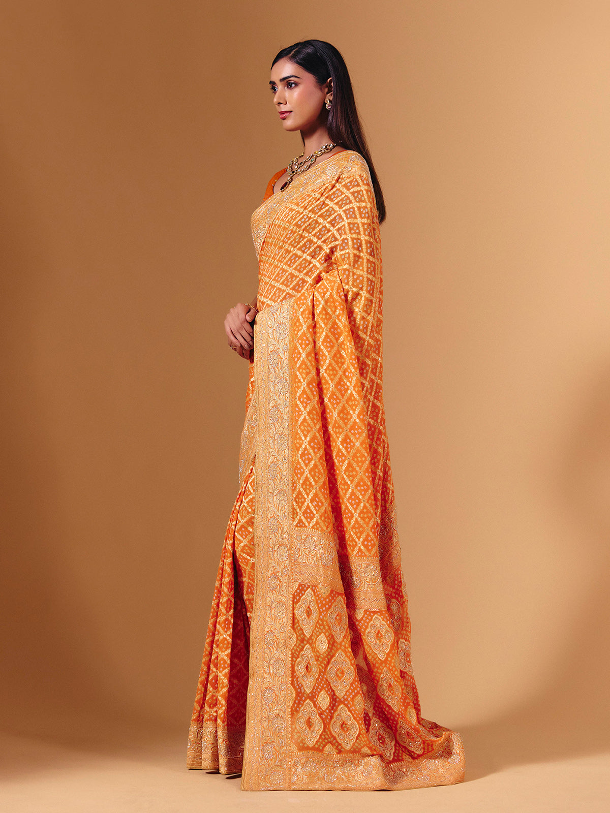 Orange georgette saree with bandhani print and zardosi embellishments