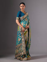 Blue dola silk saree with elegant peacock motif embellishments