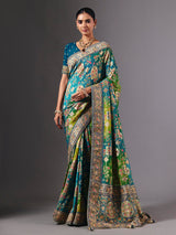 Blue dola silk saree with elegant peacock motif embellishments