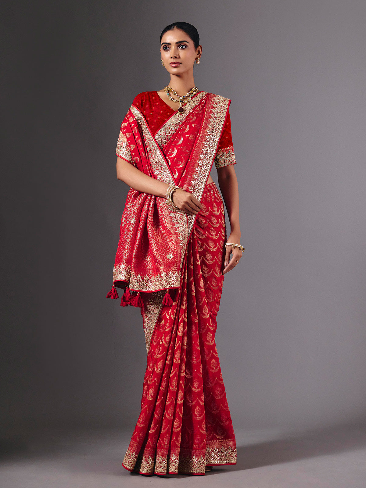 Red modal silk saree with delicate zari tassel detailing