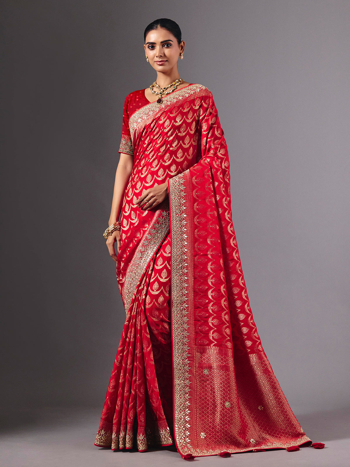 Red modal silk saree with delicate zari tassel detailing