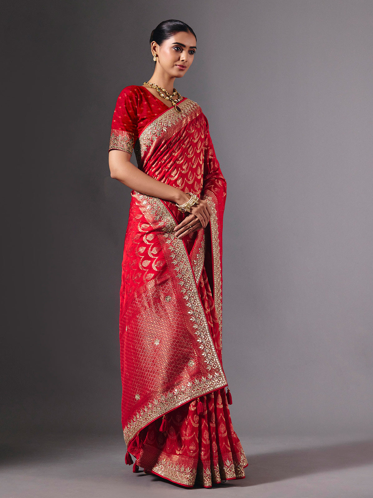 Red modal silk saree with delicate zari tassel detailing