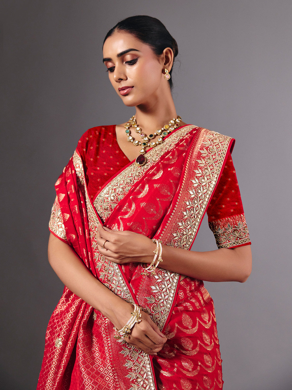Red modal silk saree with delicate zari tassel detailing