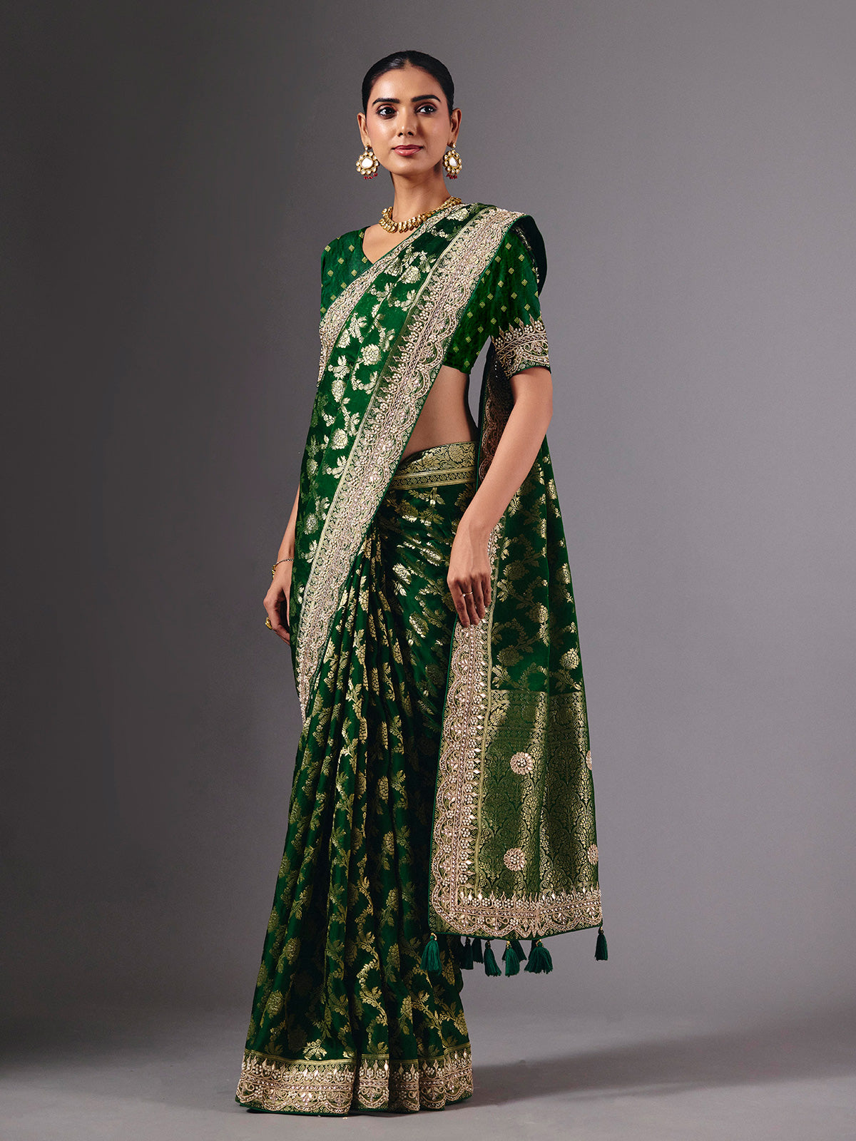 Green satin silk saree with ornate zari tassel detailing