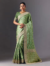 Pista green satin silk saree with ornate animal motif detailing