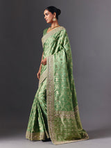 Pista green satin silk saree with ornate animal motif detailing