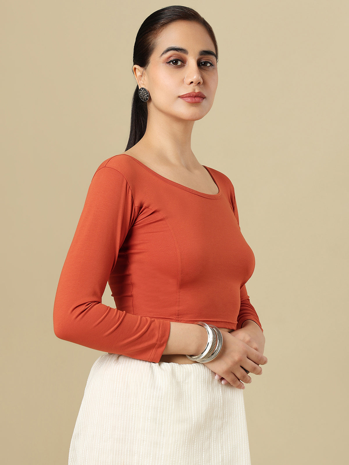 Rust orange cotton solid blouse with round neckline and quarter sleeves