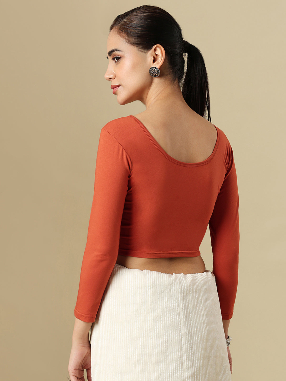 Rust orange cotton solid blouse with round neckline and quarter sleeves