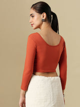 Rust orange cotton solid blouse with round neckline and quarter sleeves
