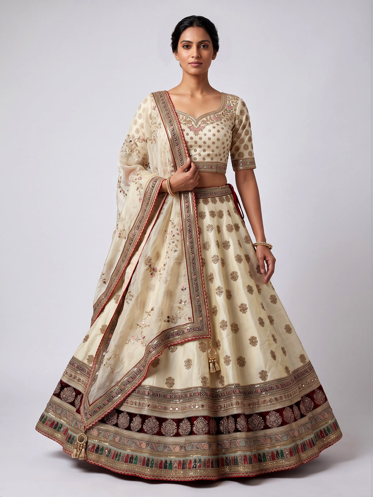 Cream silk unstitched lehenga choli with elegant butta embellishments