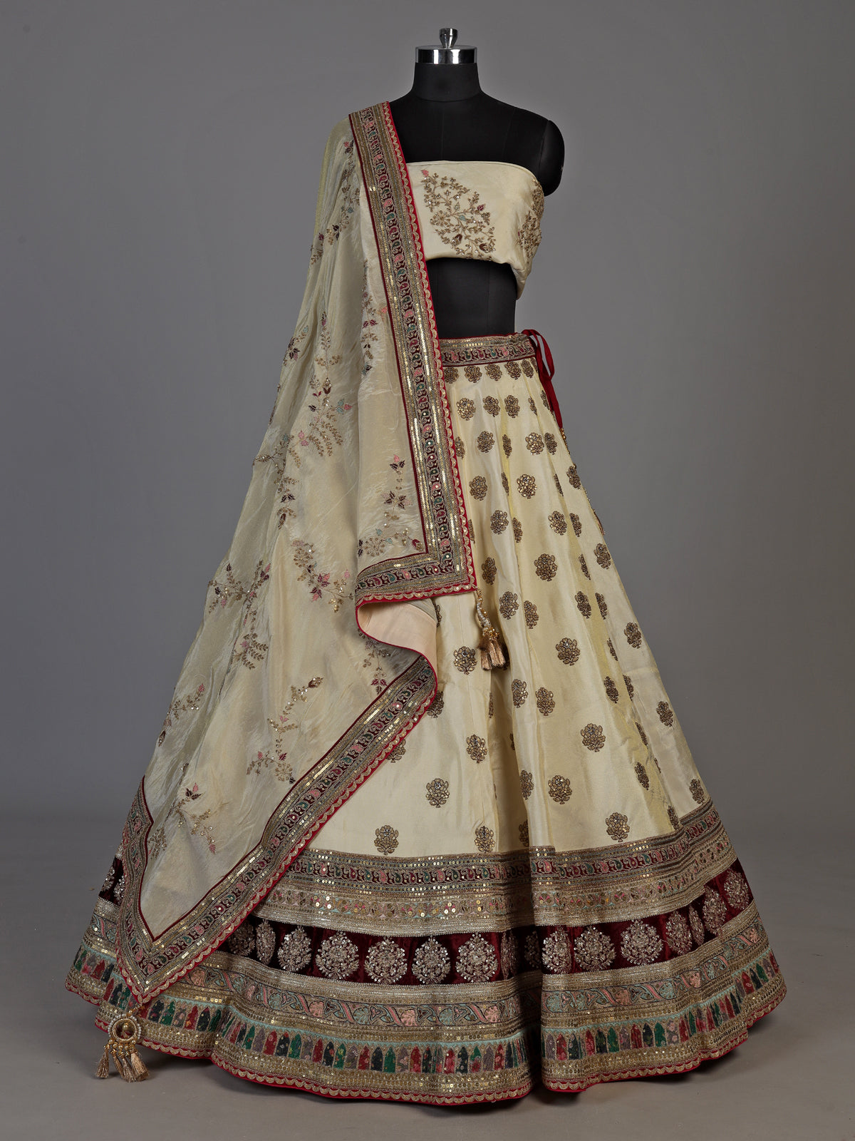 Cream silk unstitched lehenga choli with elegant butta embellishments