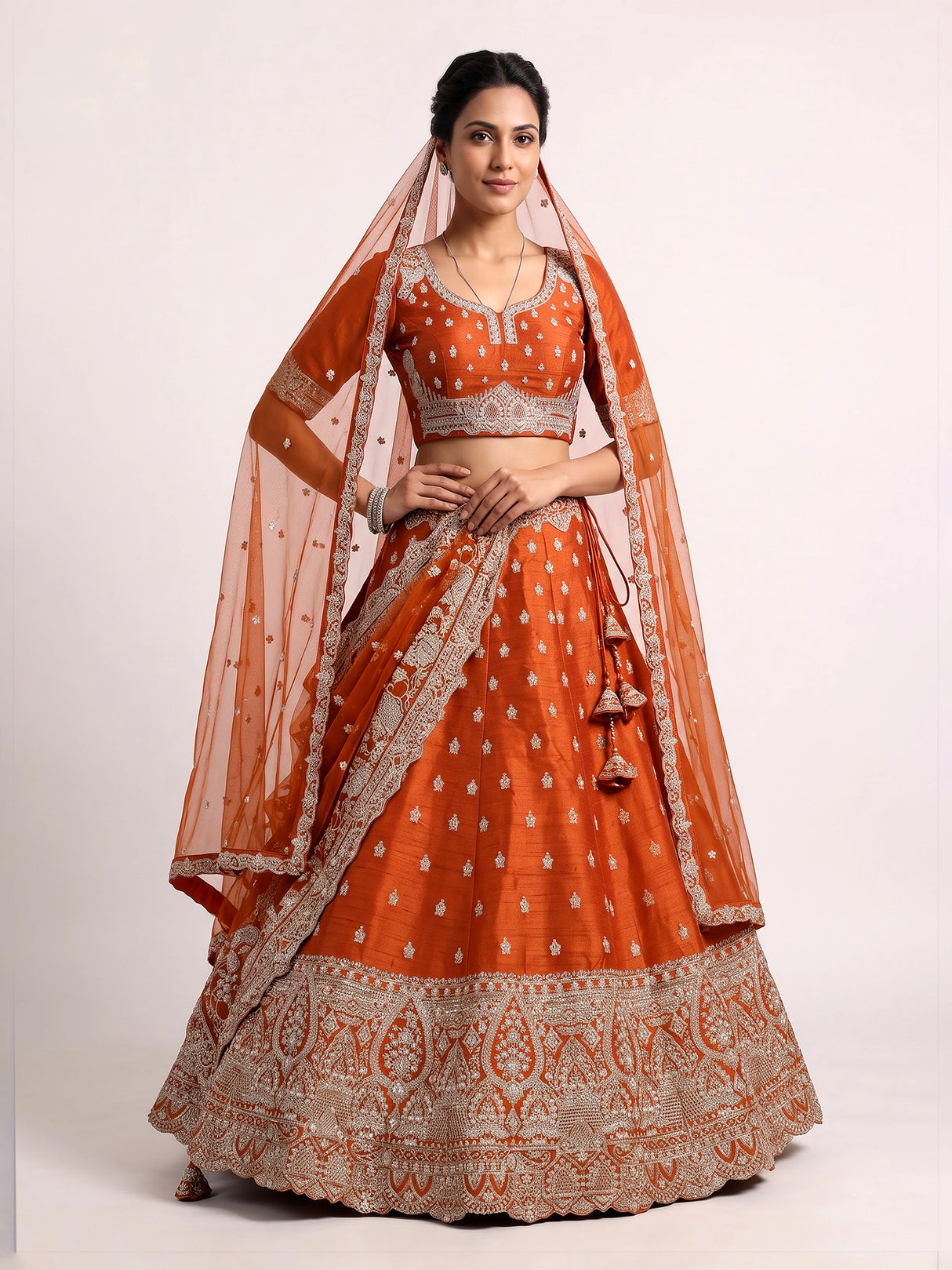 Rust orange raw silk unstitched lehenga choli with ornate butti detailing