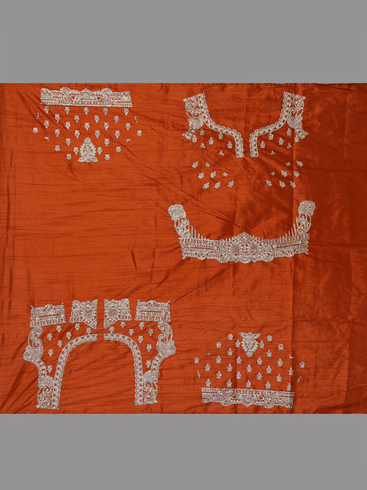 Rust orange raw silk unstitched lehenga choli with ornate butti detailing
