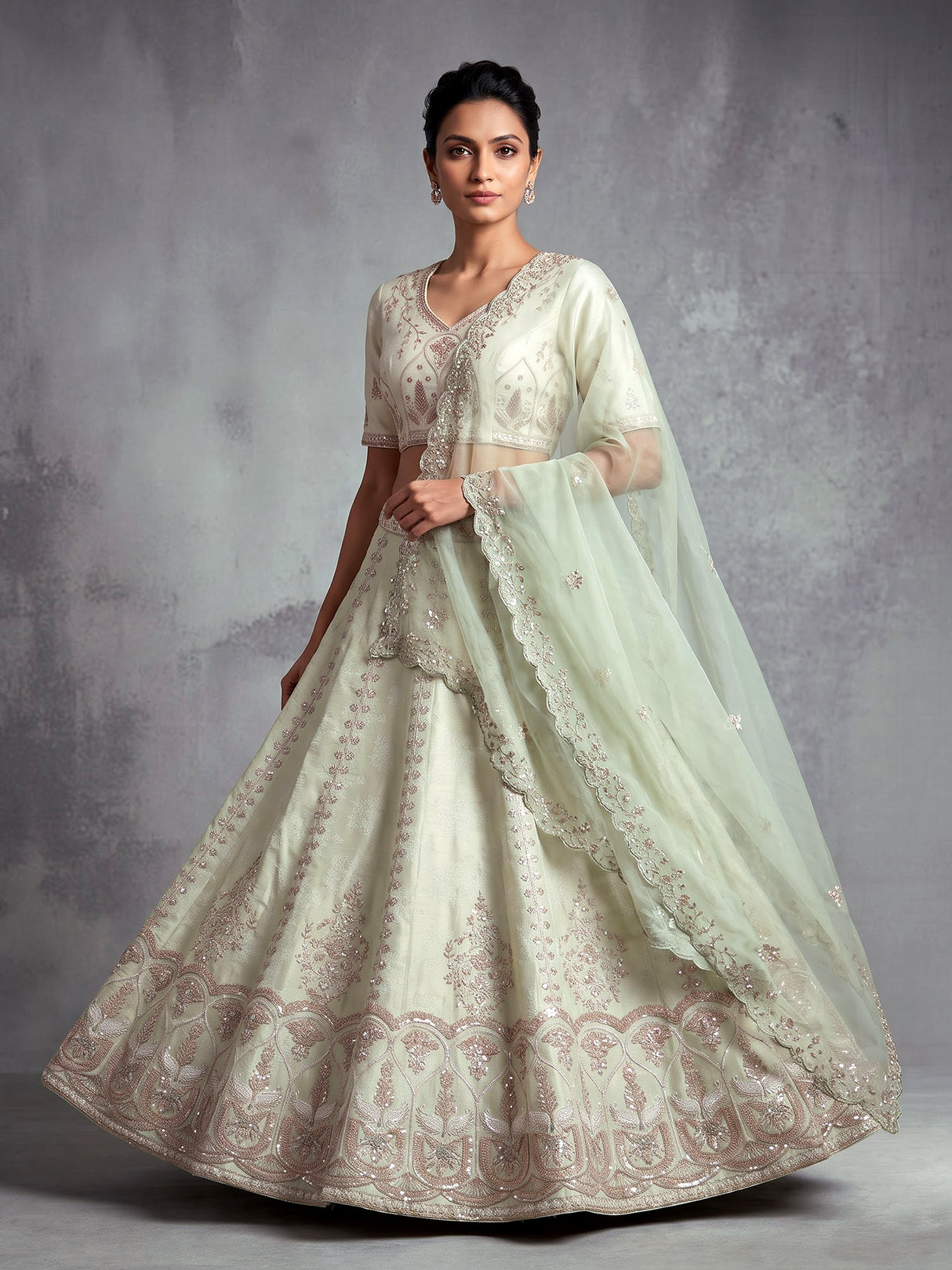 Mint green silk unstitched lehenga choli with intricate zari elegance